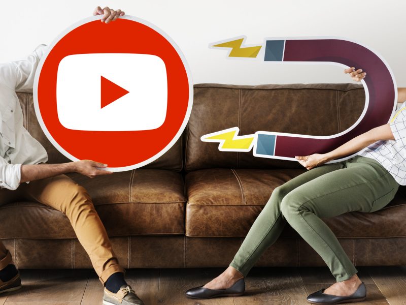 People holding a YouTube icon