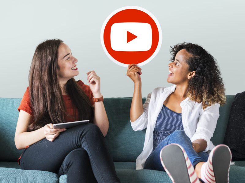 Women holding a YouTube icon